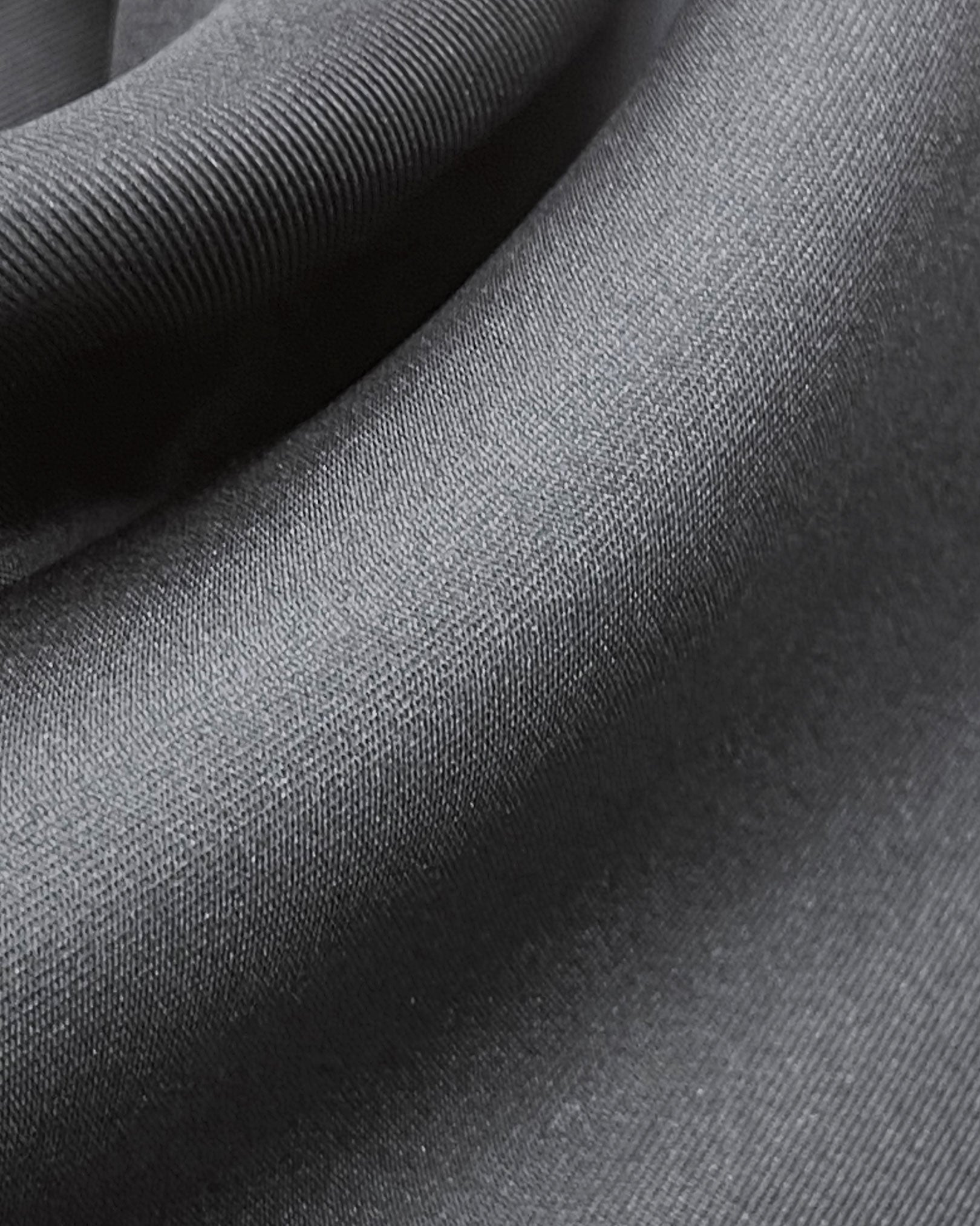 Ruffled close-up view of the 'Air Black' silk aviator scarf, presenting a closer view of the subtle lustre of the black material.