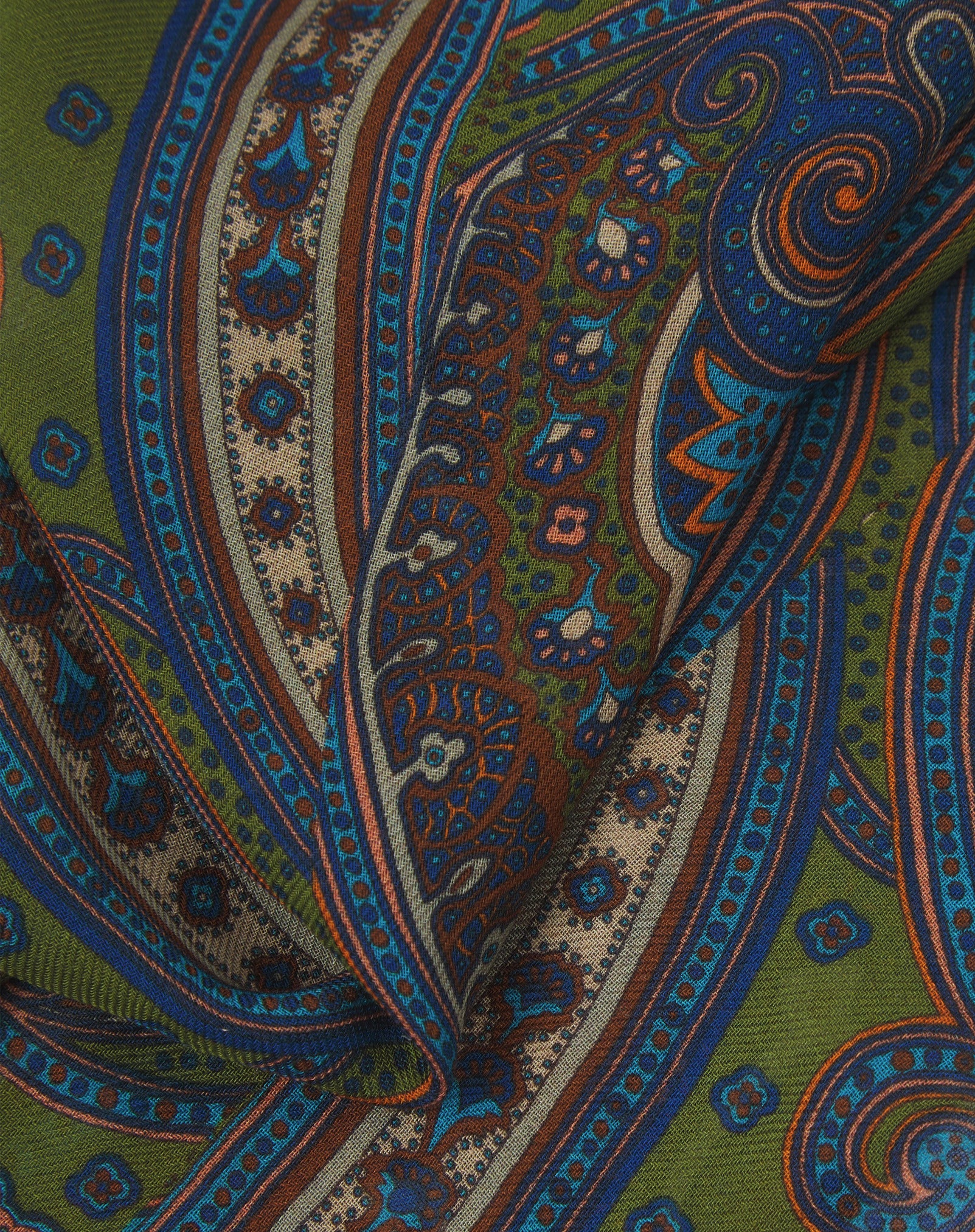 A ruffled close-up of the 'Montreal' modal and wool bandana, presenting a closer view of the paisley patterned design and modal weave.