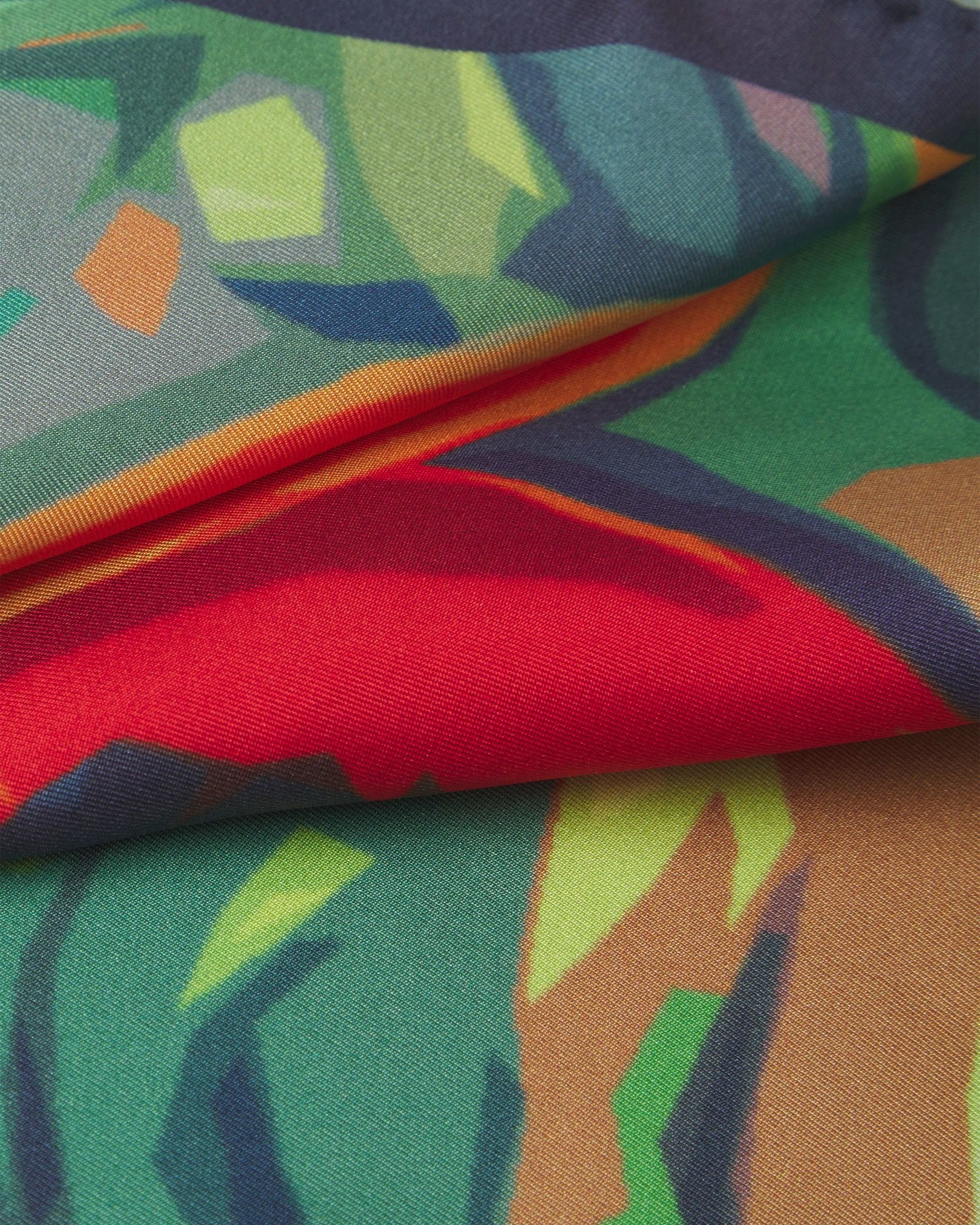 A ruffled close-up of the 'Derwent' pocket square, presenting a closer view of the striking tropical pattern on a dark background.