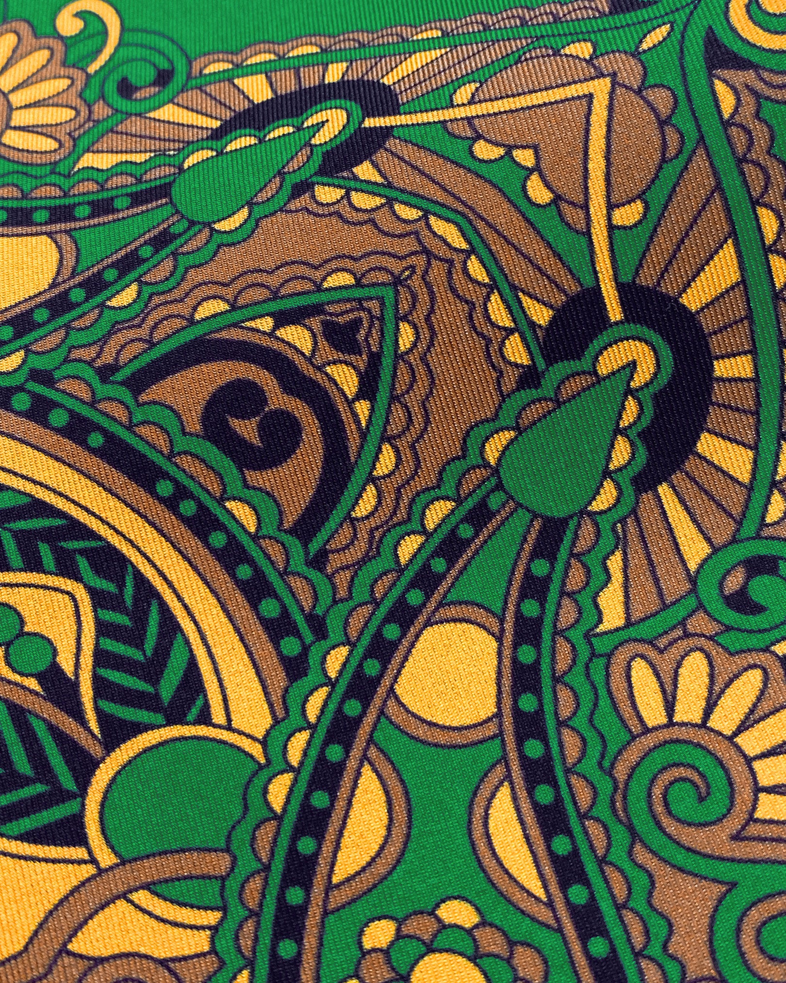 Close-up view of the Forks pocket square, presenting a closer view of the golden Fleur-de-Lis pattern on a emerald-green background and lustre of the silk material.