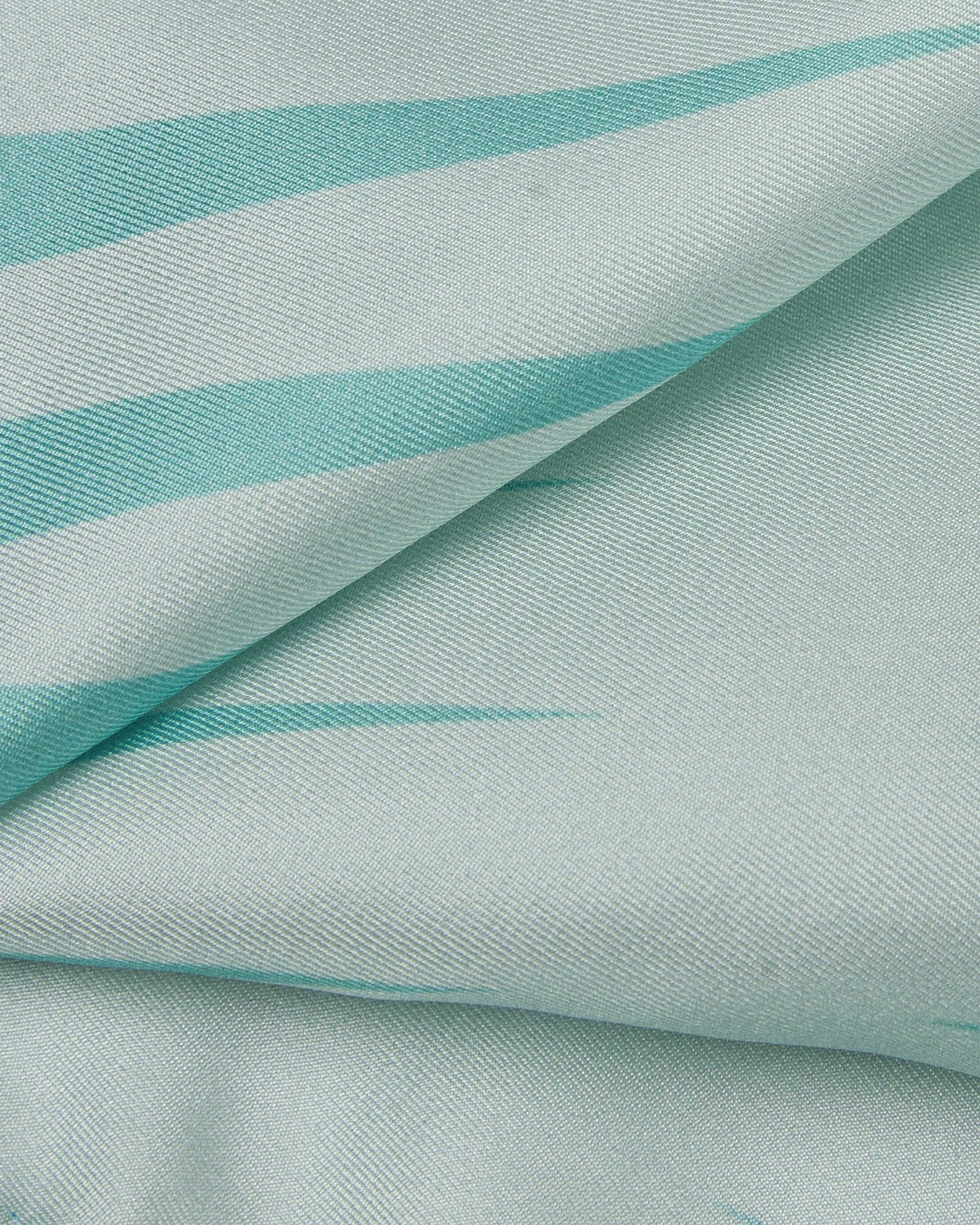 A ruffled close-up of the 'Hamburg' pocket square, presenting a closer view of the waveform-like motif of teal and turquoise.