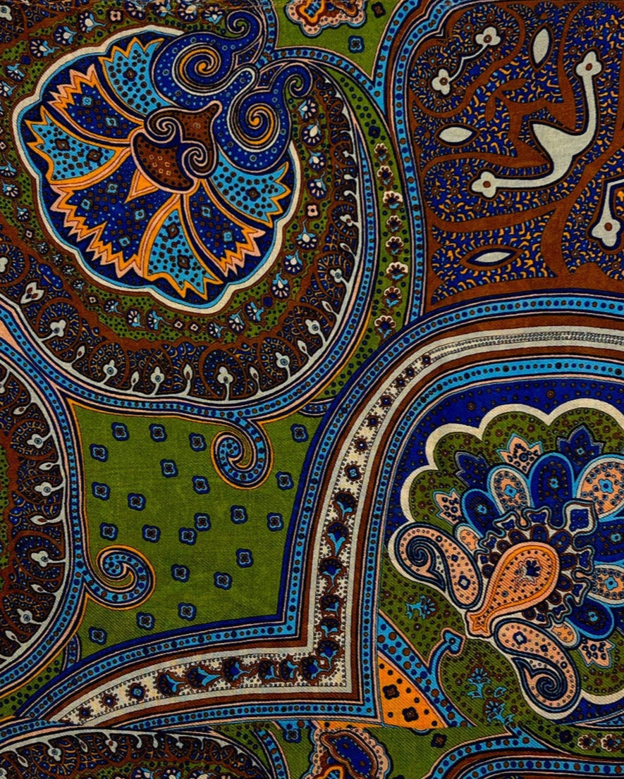 A flat close-up of the 'Montreal' modal and wool wide scarf, presenting a closer view of the large, multicoloured, paisley-like patterns.