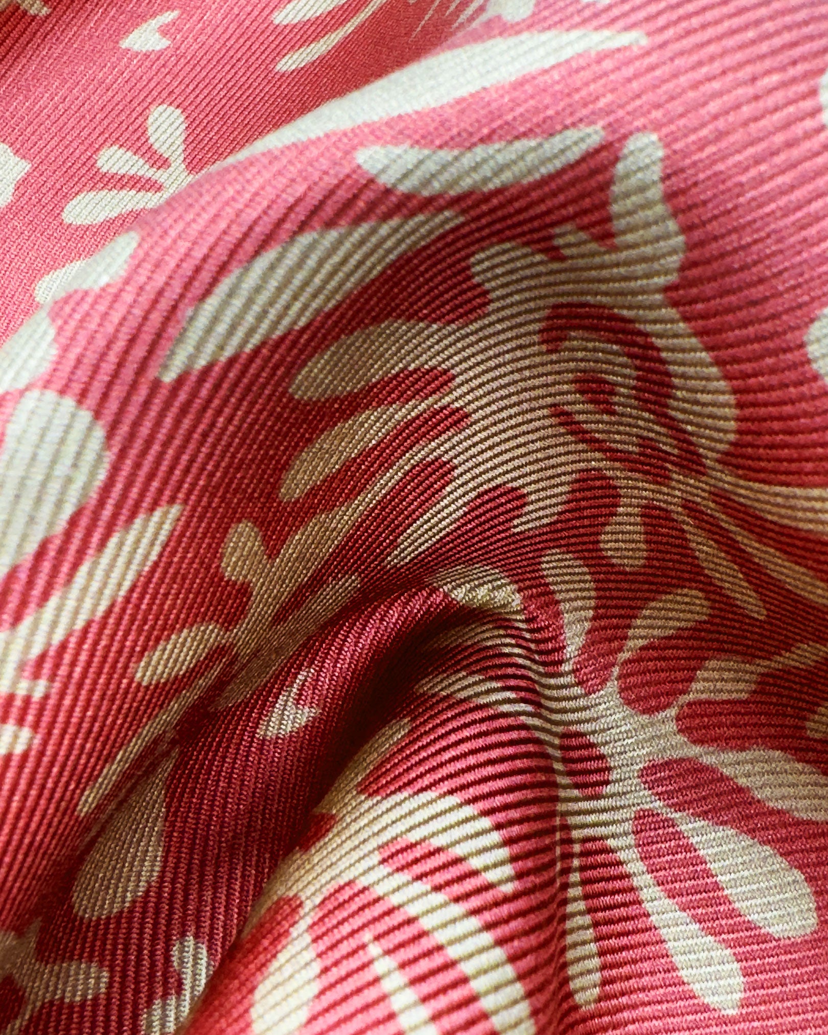 A ruffled close-up of the 'Stonehenge' pocket square, presenting a closer view of the floral-inspired patterns against the attractive lustre of the deadstock silk material. 