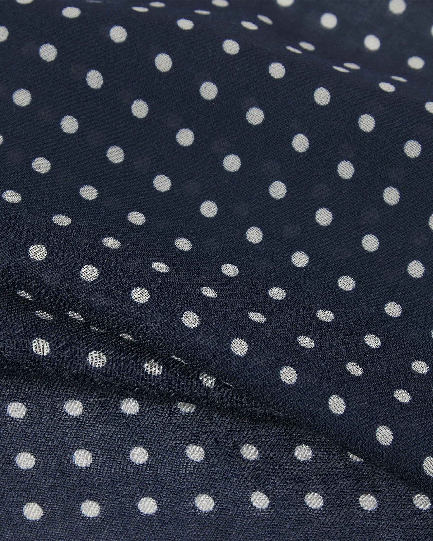 Close-up view of 'The Westminster' bandana. Ruffled and clearly showing the texture of the modal-wool blend and the polka dot pattern.