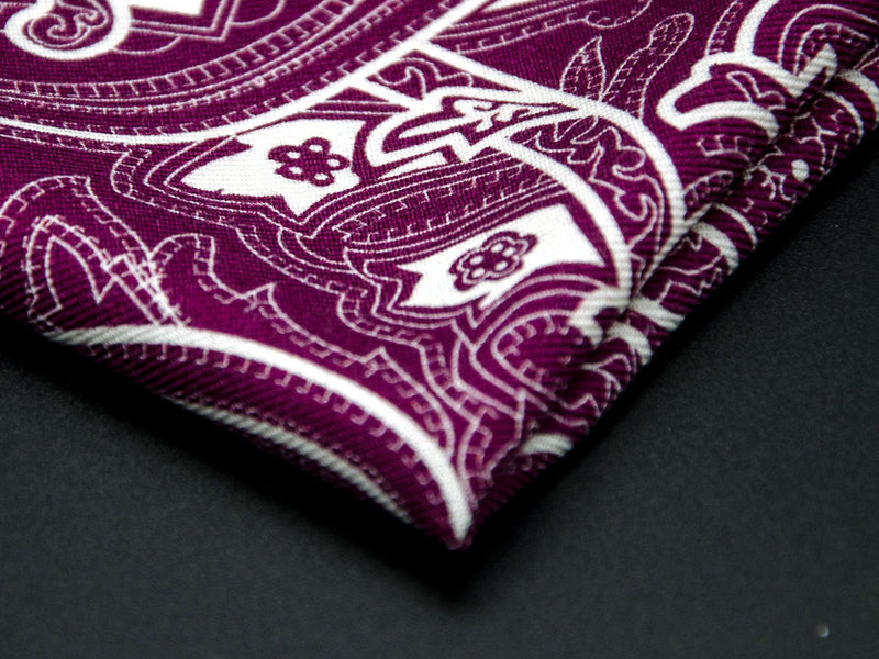 Close-up of a quarter point of the 'Kadriorg' burgundy pocket square, providing clear view of the wool weave and an even closer look at a paisley segment.