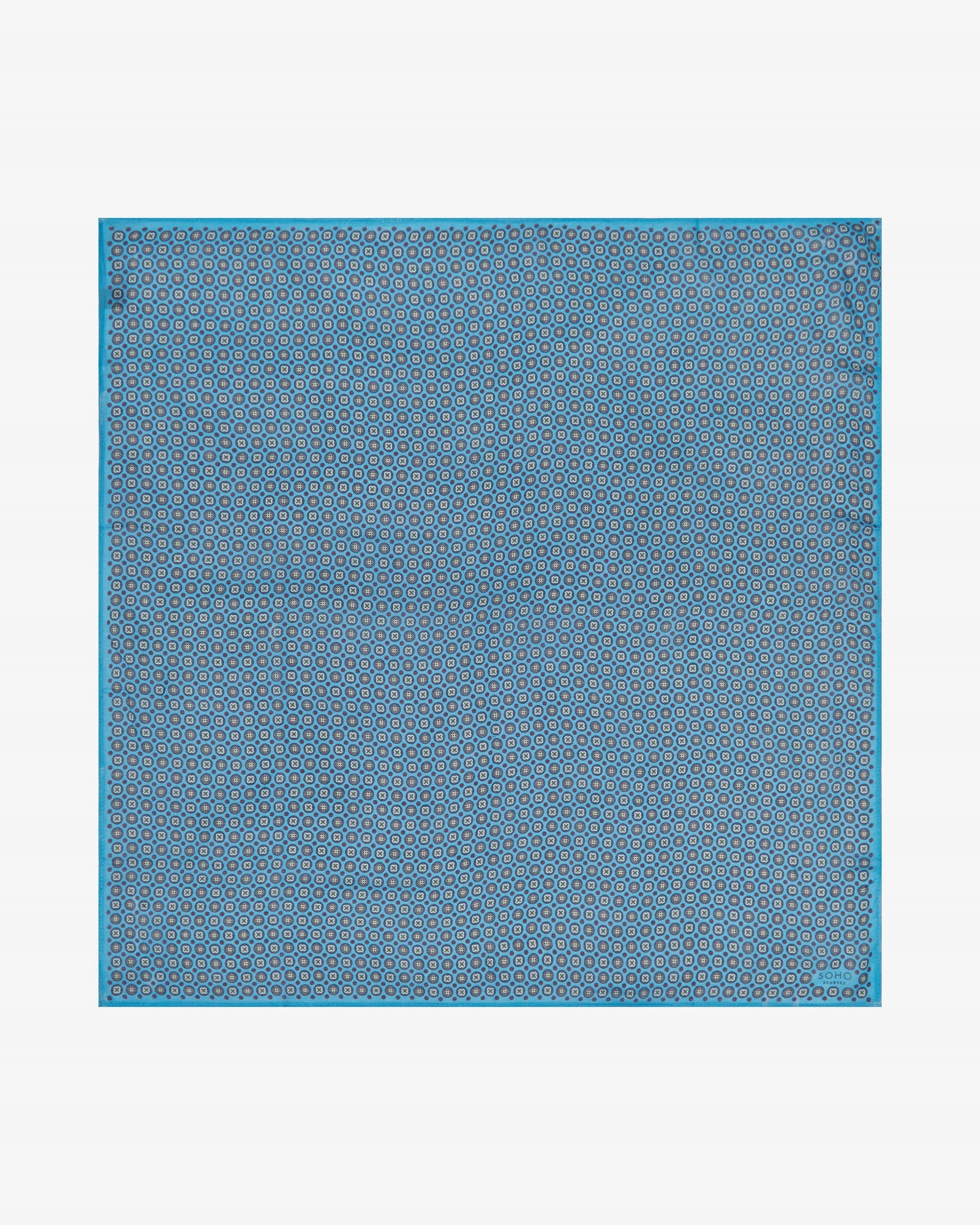 Unfolded view of 'The Toshima Gardenia' bandana. Showing the full repeat pattern of multicoloured stylised floral patterns patterns on a blue background.