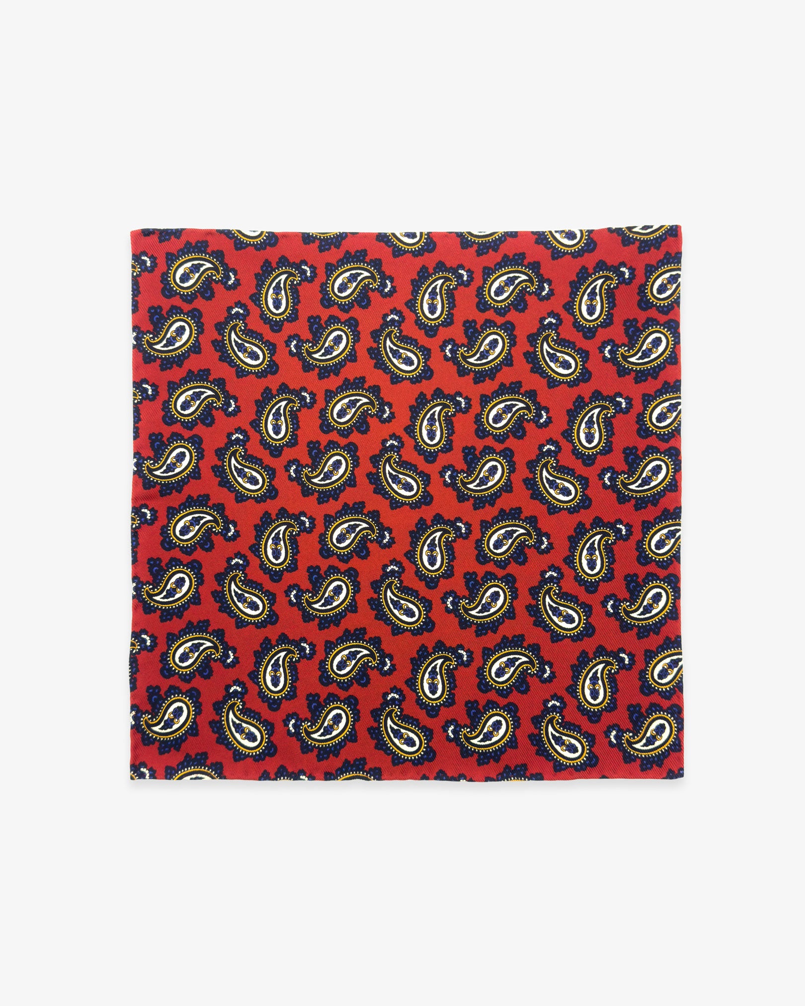 Fully unfolded 'Binham' English silk pocket square, showing the classic paisley patterns of yellow, cream and blue against a red background.