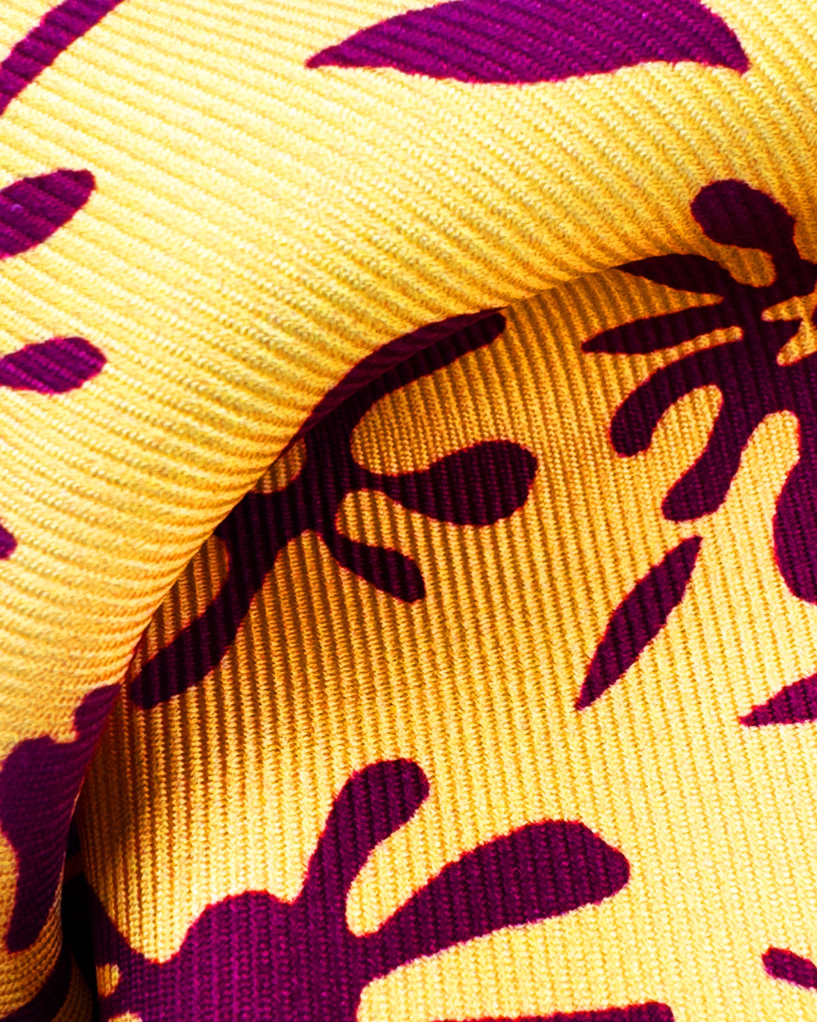 A ruffled close-up of the 'Blenheim' pocket square, presenting a closer view of the floral-inspired patterns against the attractive lustre of the deadstock silk material. 