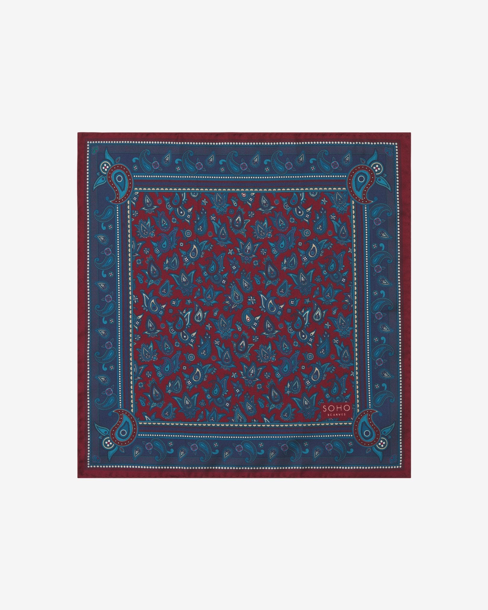 Fully unfolded 'Buttermere' silk pocket square, clearly displaying the blue and blue-green paisley patterns on an rust background, framed with an ornate border.