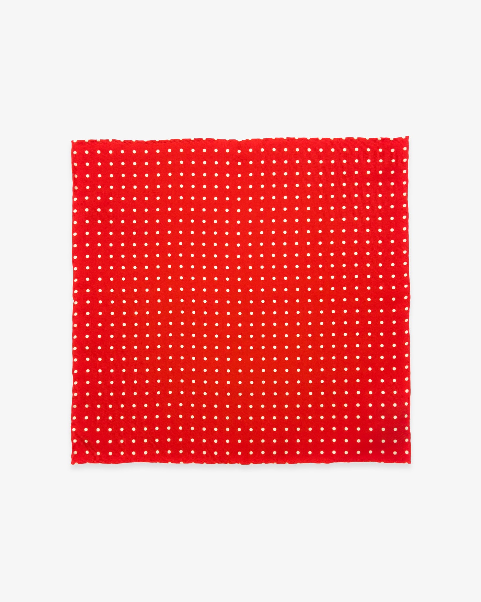 Fully unfolded 'Hastings' English silk pocket square, showing the classic linear spotty decoration against a vibrant red background.