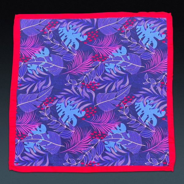 Fully unfolded 'Mersey' silk pocket square, showing the stylised leaf montage in purple, pink and blue on a dark blue background and bright red border.