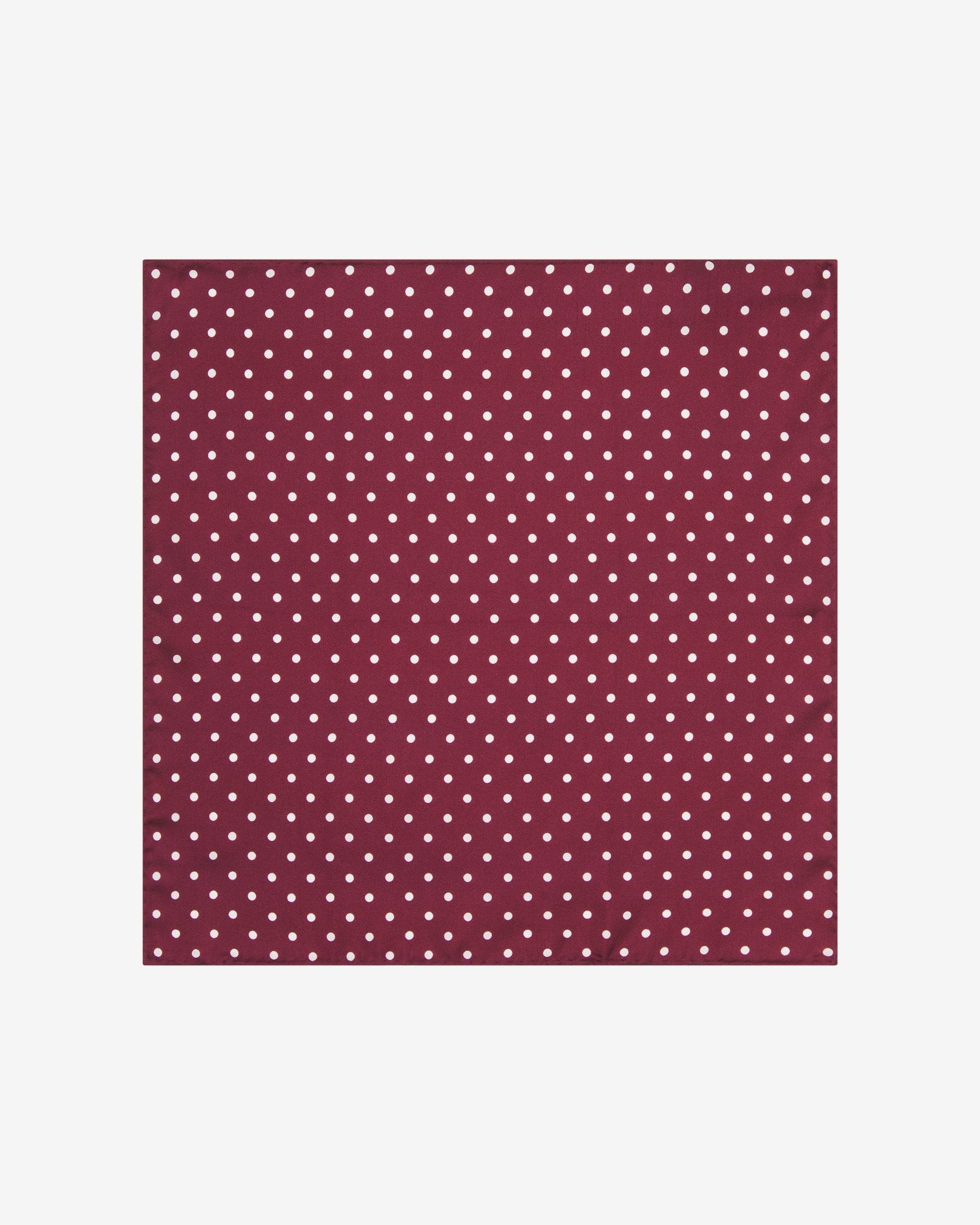 Fully unfolded 'Sapporo' silk pocket square, showing the burgundy fabric complemented by small white dots.