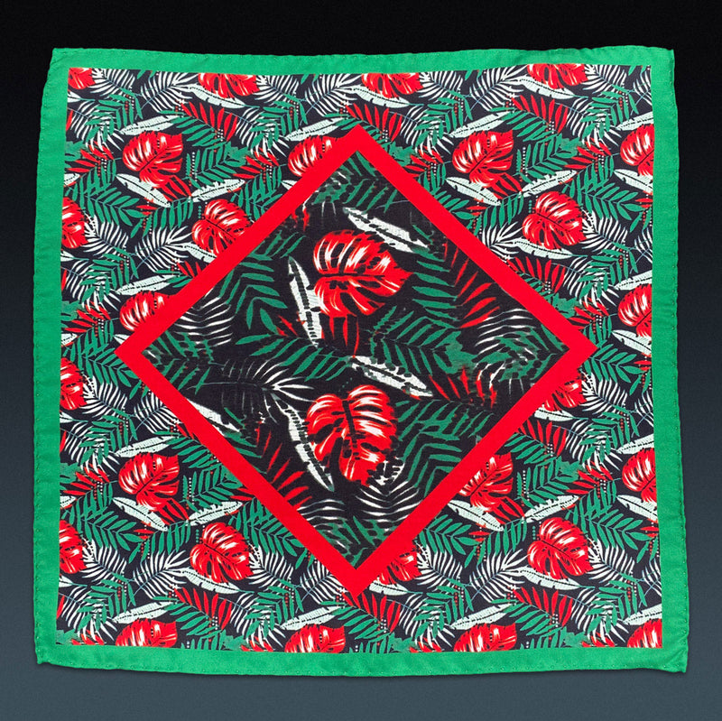 Fully unfolded 'Swayle' silk pocket square, showing the green, red and white leaf pattern and green border.