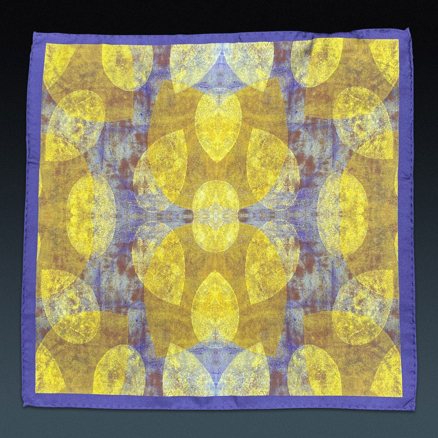Fully unfolded 'Tweed' silk pocket square, showing the pattern of stylised leaf forms creating a yellow and purple textured effect.