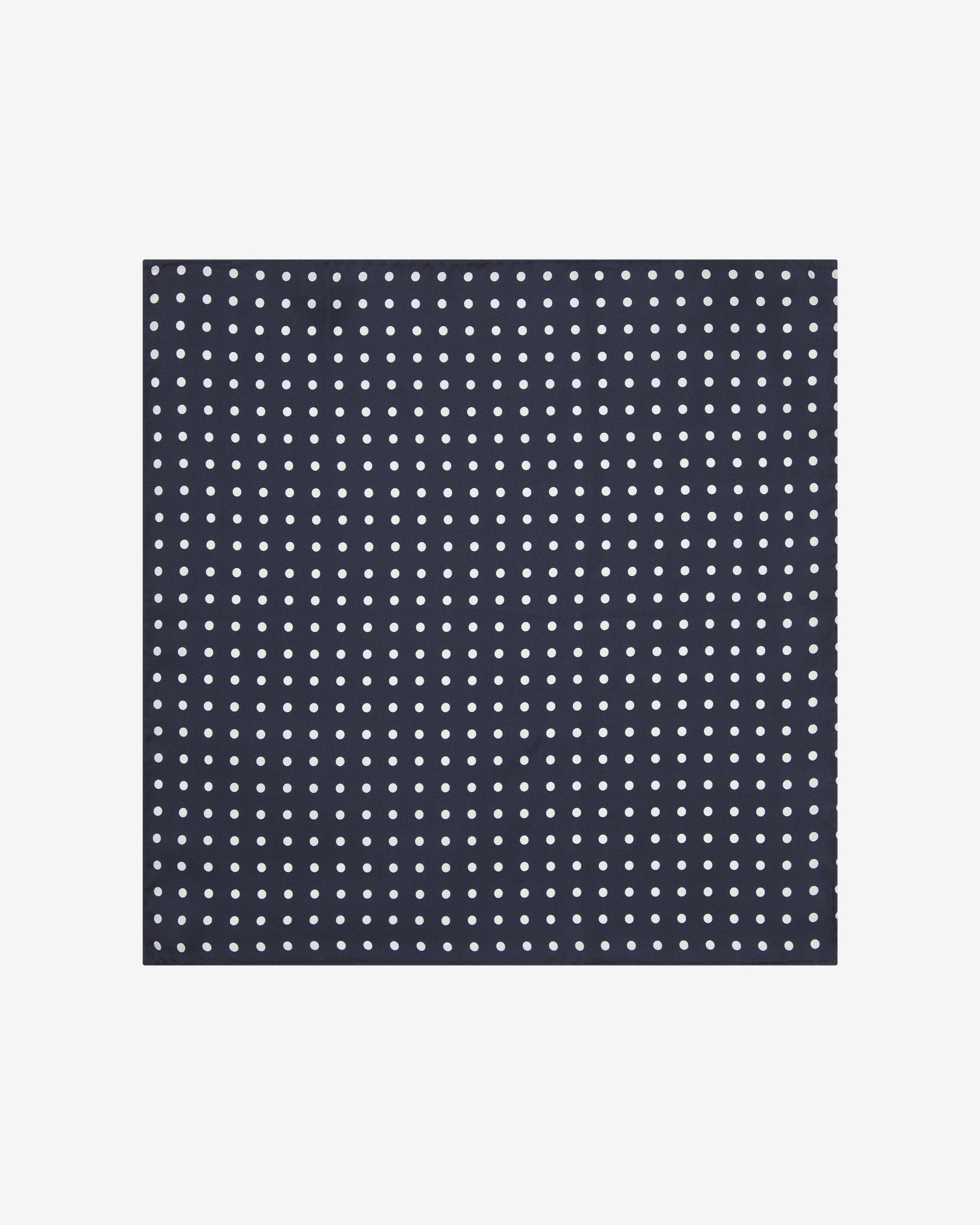 Fully unfolded 'Westminster' silk pocket square, showing the polka dot pattern set on a deep blue fabric background.