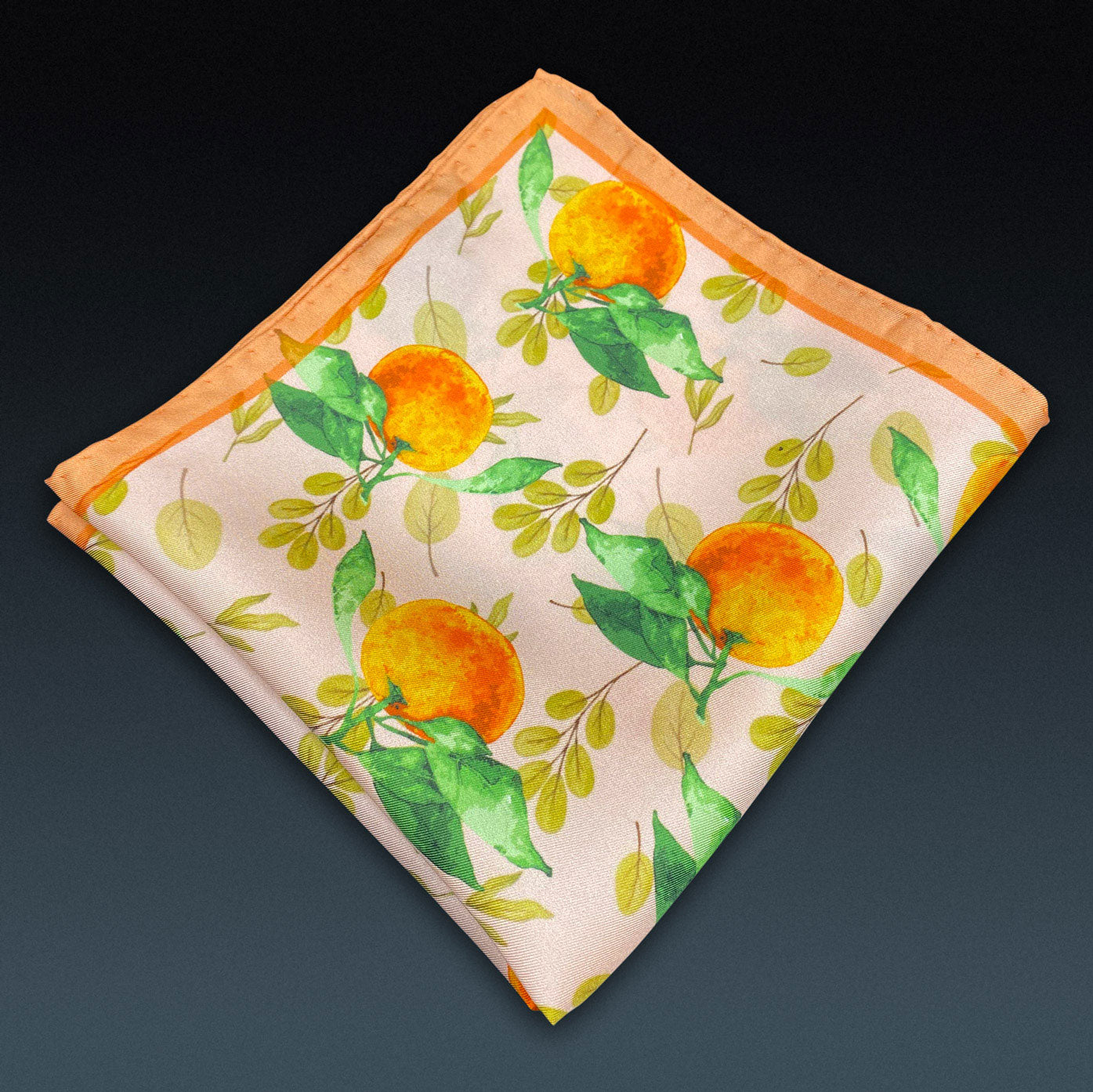 Folded 'Aire' silk pocket square from SOHO Scarves, showing the attractive orange and leaf pattern on a dark background.