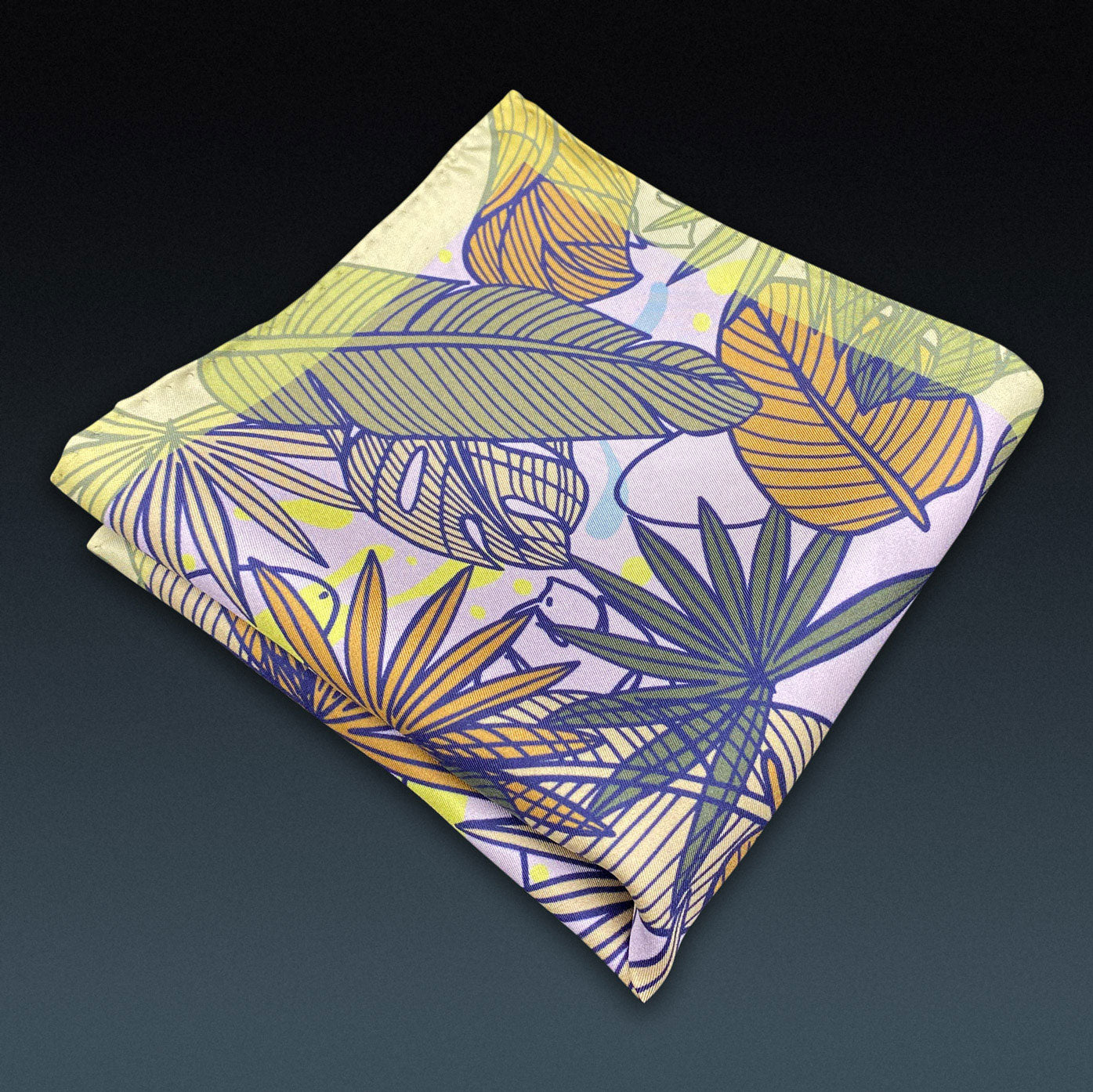 Folded 'Avon' silk pocket square from SOHO Scarves, showing the leaf montage pattern. Placed on a dark background.