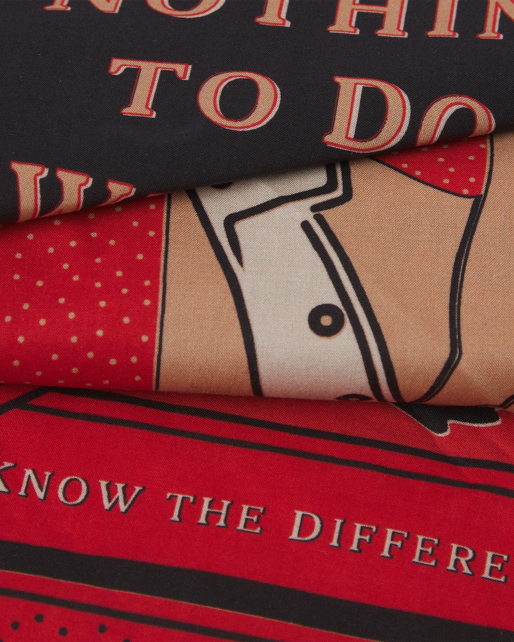 A ruffled, close-up view of the crimson, fawn and black 'Luck' Old West-style bandana from Soho Scarves.