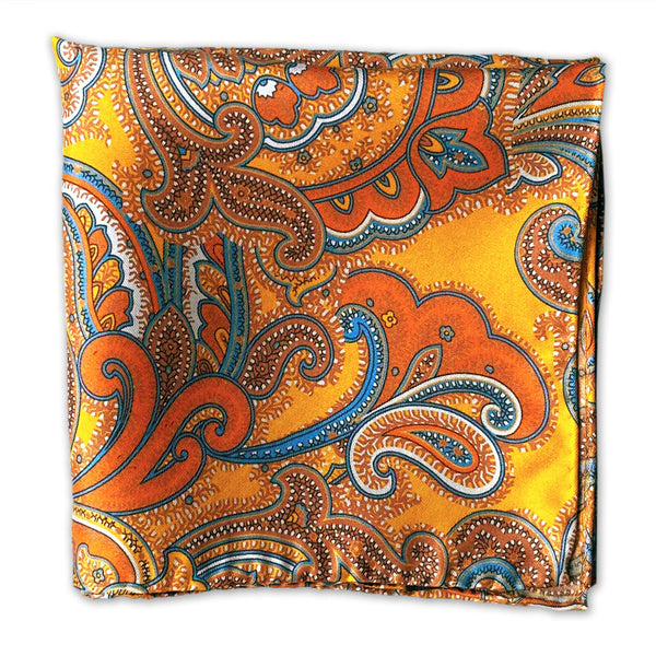 Silk pocket square square folded into a quarter, clearly displaying the deep orange, light blue and brown paisley patterns on a gold background.