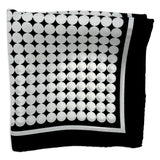 Keaton silk pocket square folded into a quarter, showing white circles tightly packed in straight lines on a black background, neatly framed with a white border.