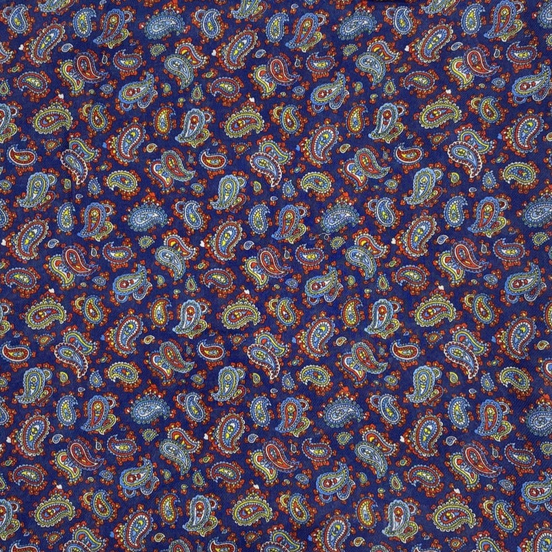 A flat, folded view of 'The Lexington' bandana. Clearly showing the intricate multicoloured paisley patterns on a midnight blue background.