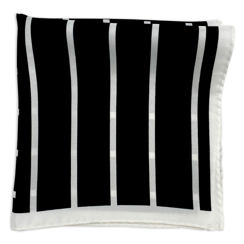 Lloyd silk pocket square folded into a quarter, showing white vertical stripes on a black background, neatly framed with a white border.