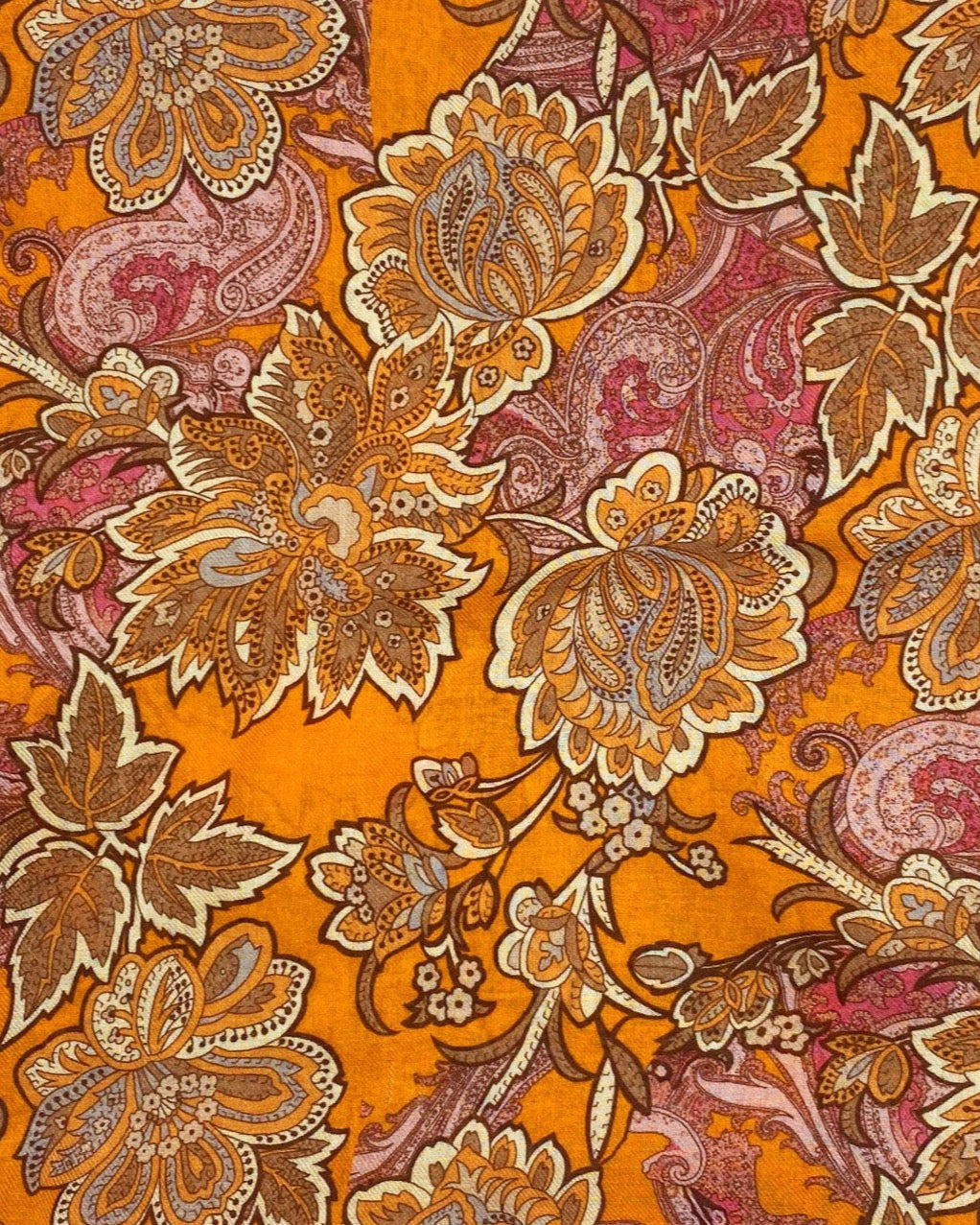 A flat, folded view of 'The Niagra' bandana. Clearly showing the intricate floral and leaf patterns in various shades of orange and pink on a deep orange background.