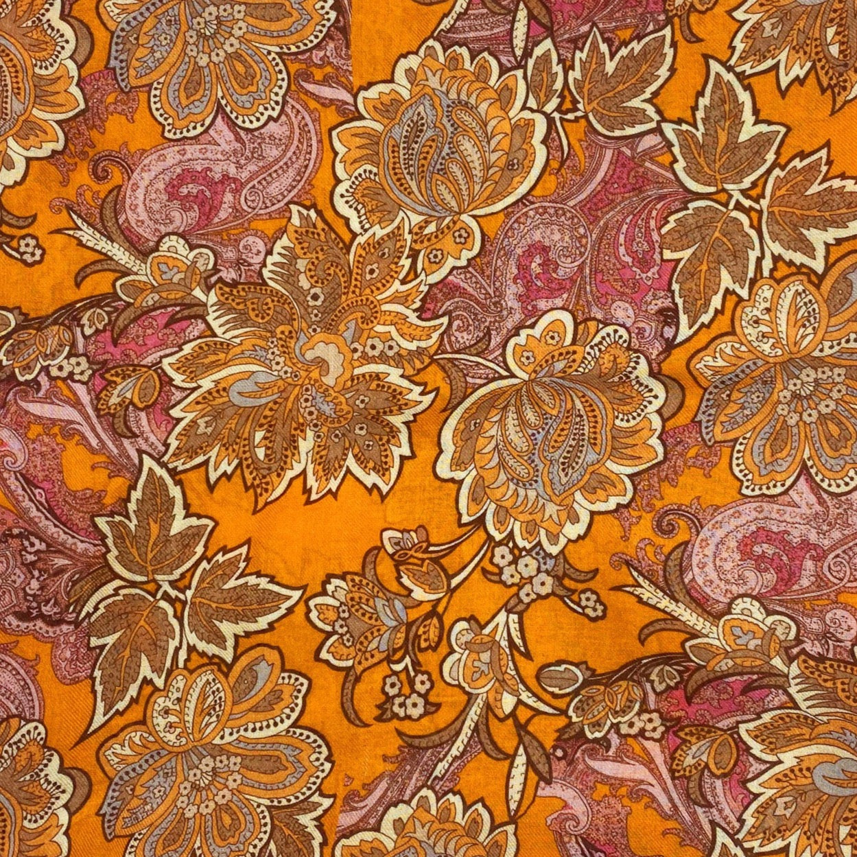 A flat, folded view of 'The Niagra' wide scarf. Clearly showing the intricate floral and leaf patterns in various shades of orange and pink on a deep orange background.
