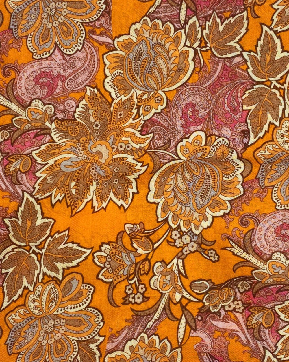 A flat, folded view of 'The Niagra' wide scarf. Clearly showing the intricate floral and leaf patterns in various shades of orange and pink on a deep orange background.