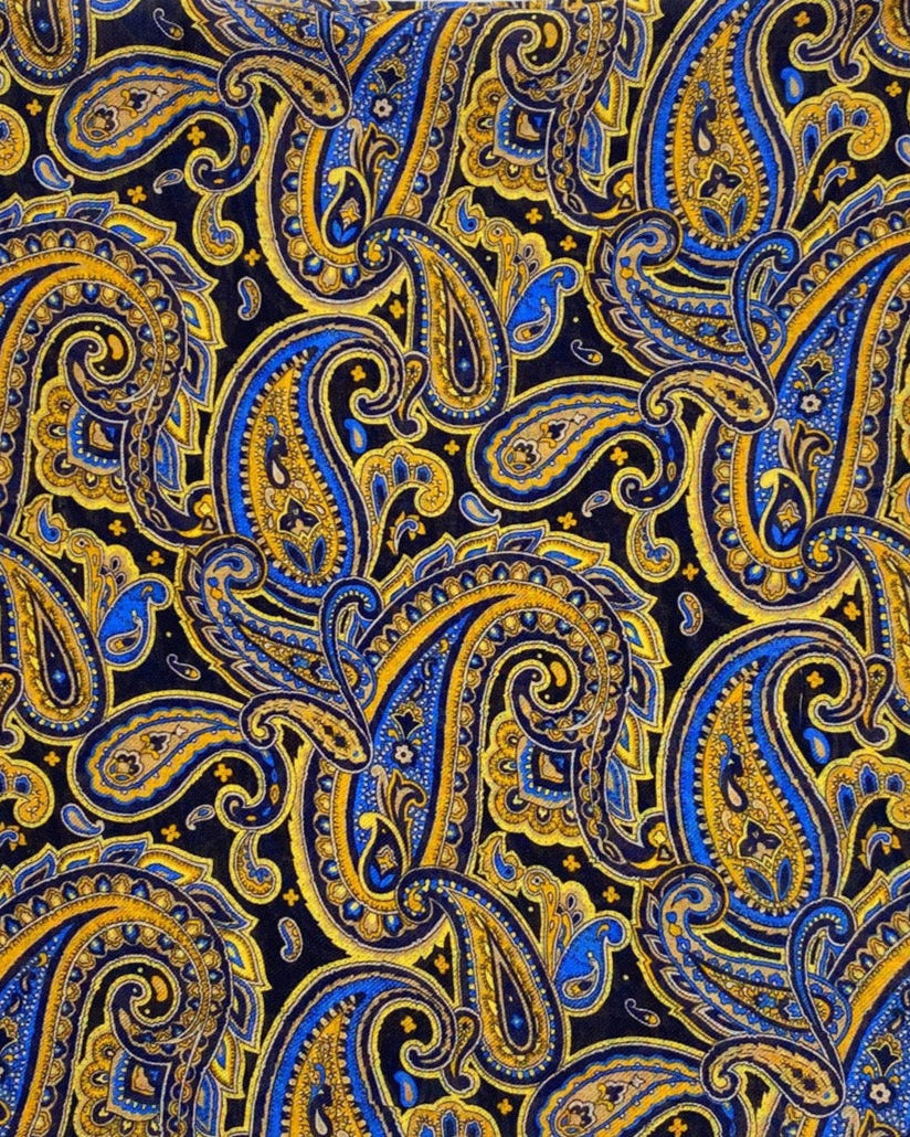 A flat, folded view of 'The Ormond' bandana. Clearly showing the intricate paisley patterns in blue, yellow and gold on a black background.