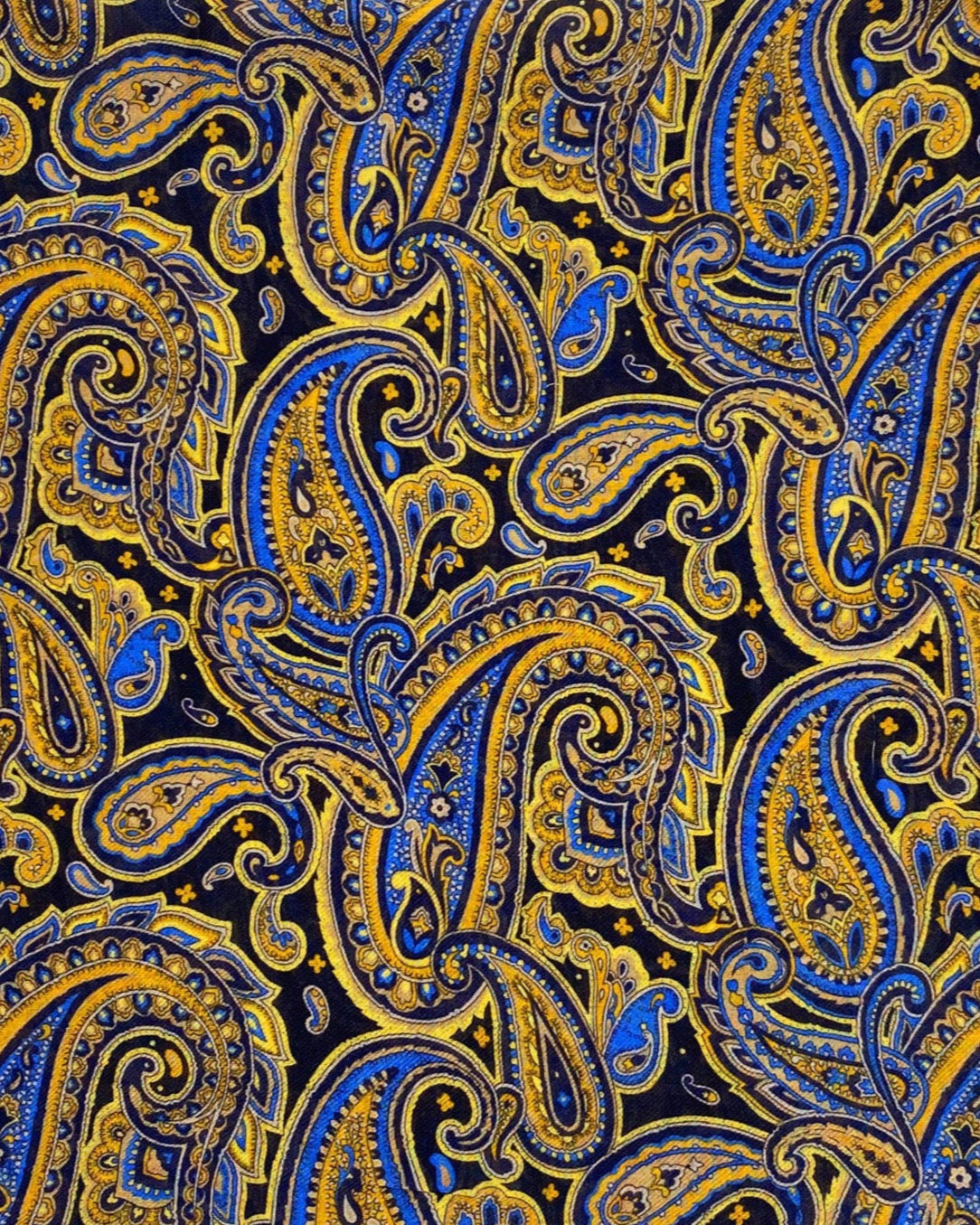 A flat, folded view of 'The Ormond' boho wide scarf. Clearly showing the intricate paisley patterns in blue, yellow and gold on a black background.