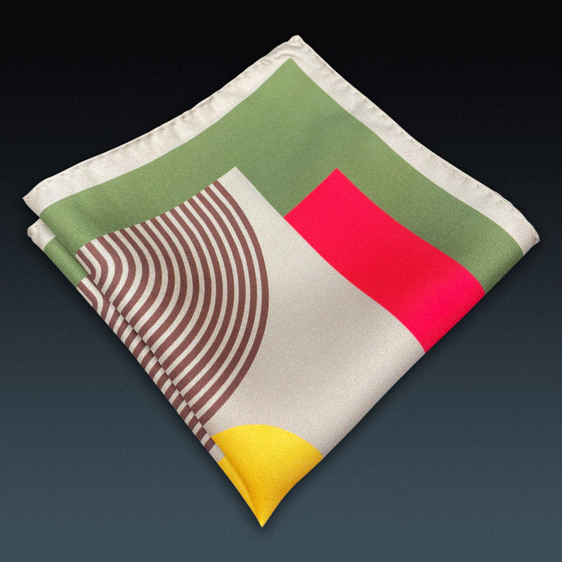 Folded 'Tay' silk pocket square from SOHO Scarves, showing the retro geometric pattern.