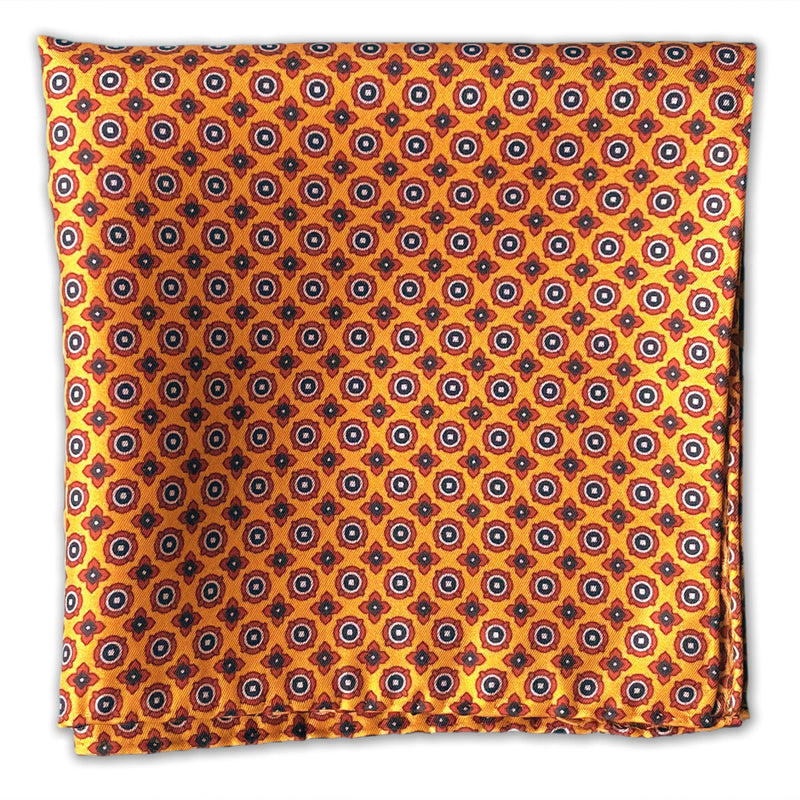 Flat view of the 'Toshima' pocket accessory, presenting a closer view of the small blue and red stylised floral patterns on a golden-orange ground.