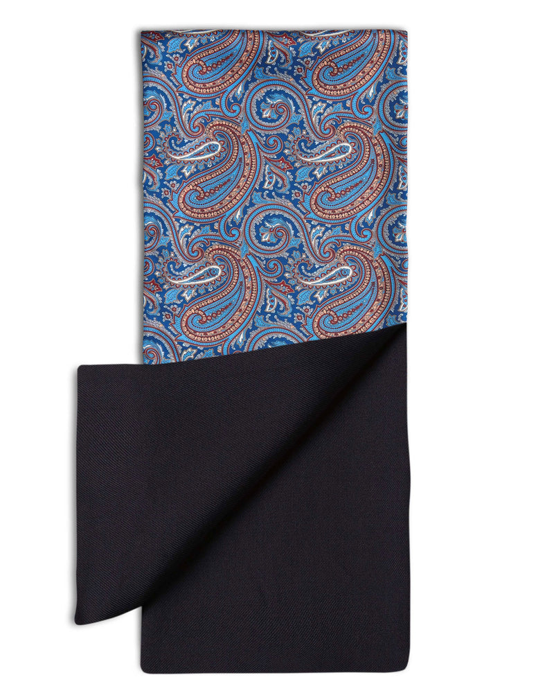 'The Sullivan' dress scarf arranged in a rectangular shape clearly showing the light blue, pink and burgundy paisley patterns. The bottom-right quadrant is folded back to reveal the fine woollen lining underneath the pure silk exterior.