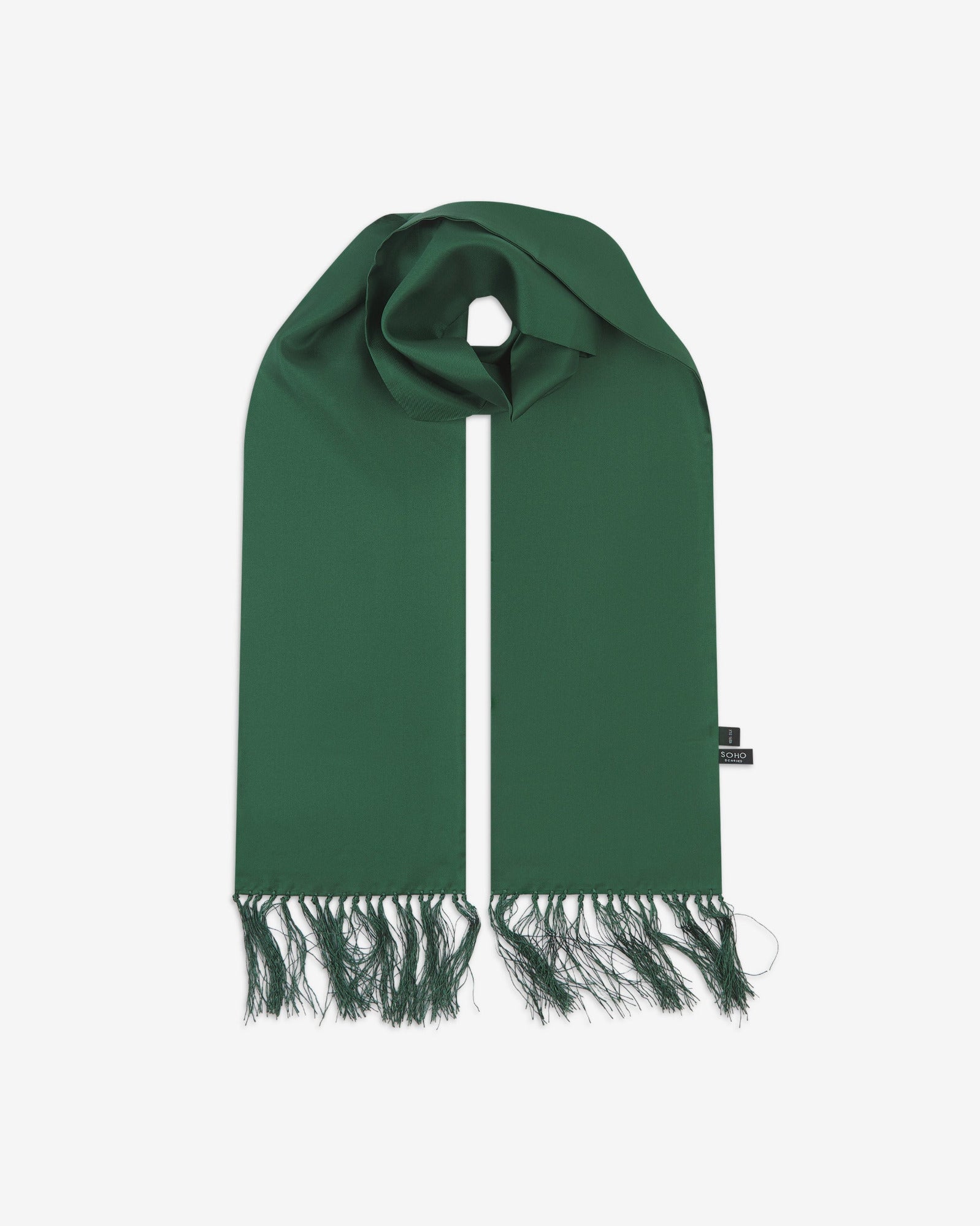 Green silk aviator scarf from Soho Scarves. Looped with both ends parallel showing the branding label to the right and the matching 8cm long fringes.