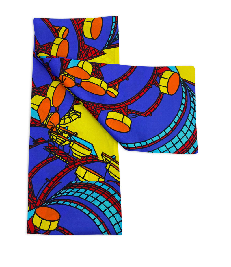 Yellow version of the BT Tower multicoloured  pattern scarf arranged in a rectangular shape and folded inwards to create an 'r' shape, clearly showing the tower motif.