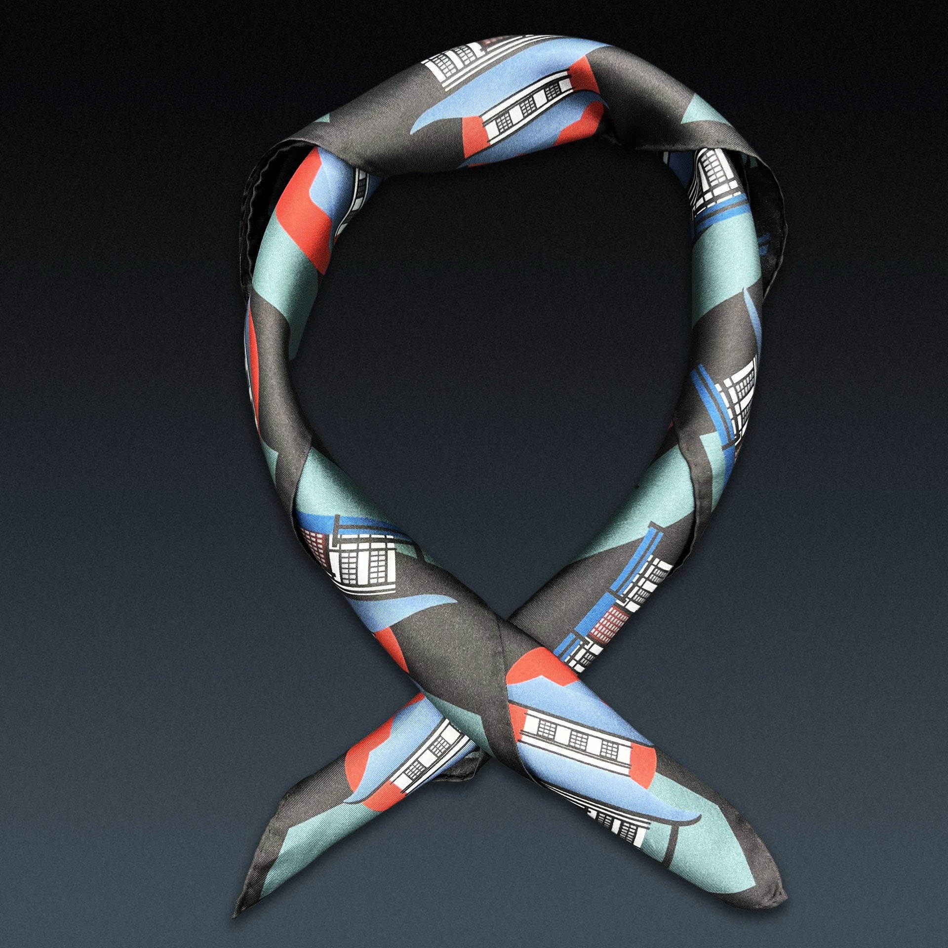 'The House' neckerchief twisted and curled into a loop on a dark background.