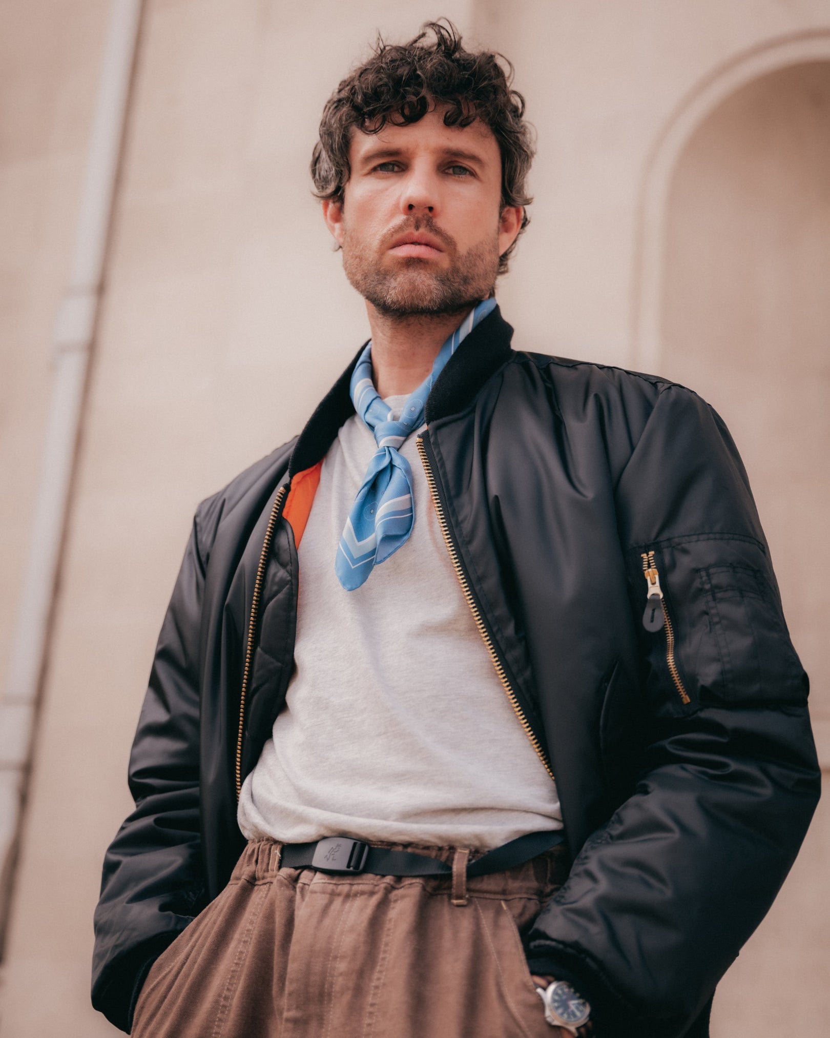 Top-half view of man wearing the 'Islington' silk neckerchief in cornflower blue from SOHO Scarves.