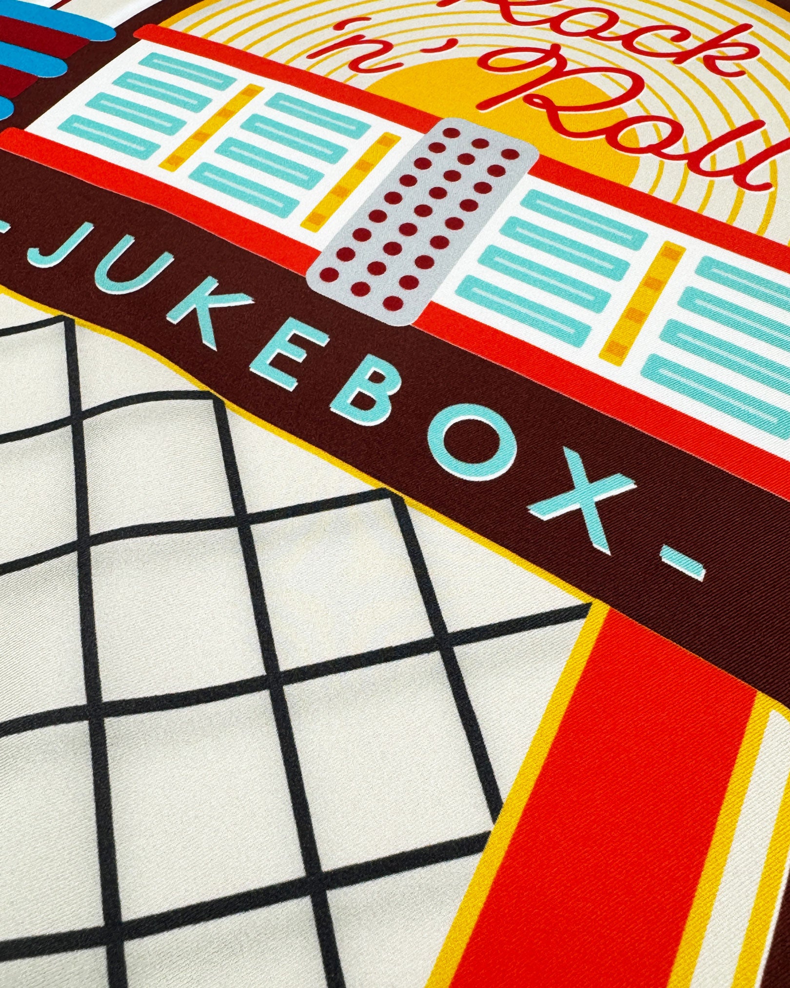 A close-up of the 'Jukebox' silk neckerchief, presenting a closer look at a the bold colours of the 1950's jukebox.