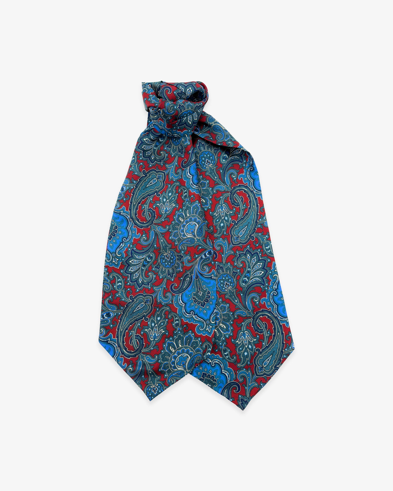The Dean double Ascot tie with wide ends at the bottom and clear view of the blue paisley patterns against a deep red ground.