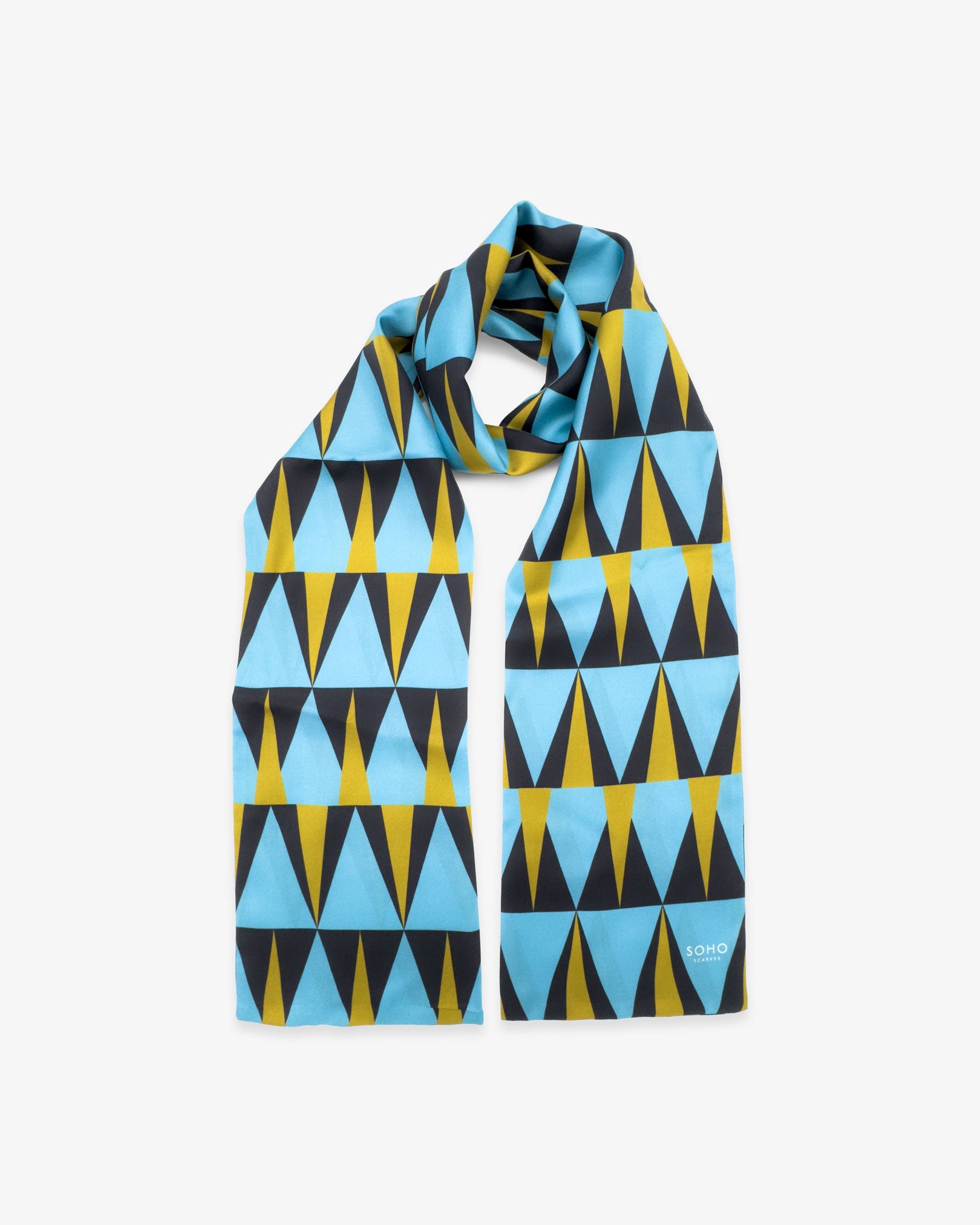 The 'Leipzig' Bauhaus-inspired silk scarf looped with both ends parallel to effectively display the full repeat pattern of pale blue, charcoal grey and yellow triangles.