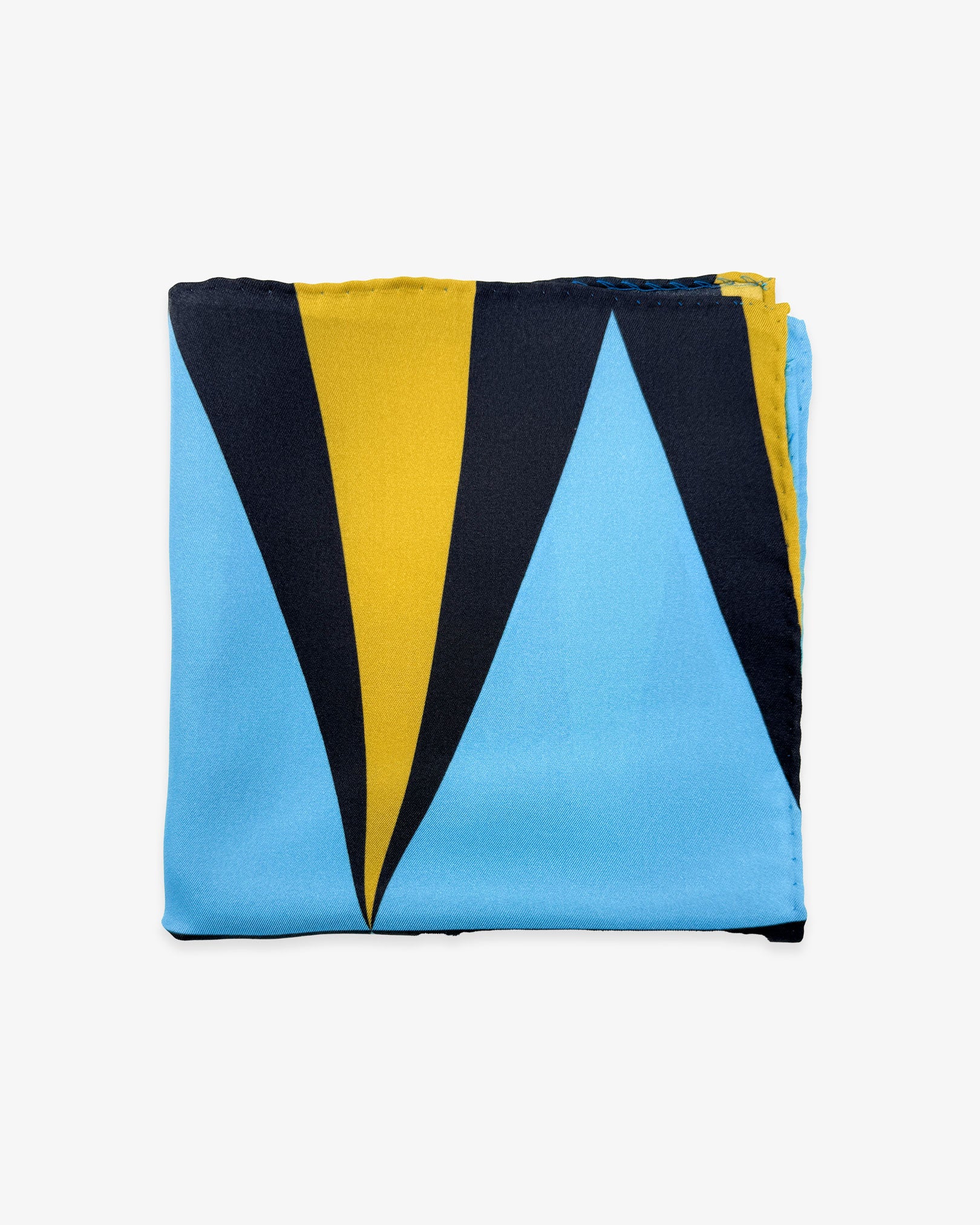 The 'Leipzig' silk pocket square from SOHO Scarves folded into a quarter, showing a portion of the bauhaus-inspired triangular forms.