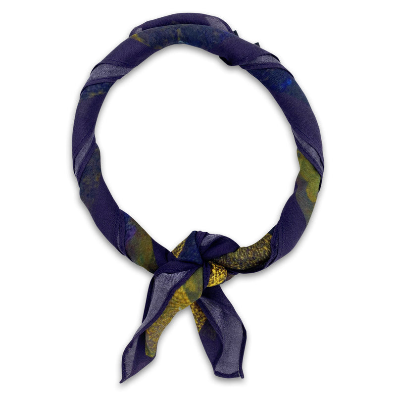 The Alps bandana knotted into a loop, showing the subtle violet and blue tones of the modal-wool fabric.