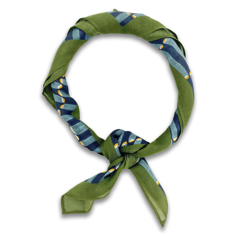 The Atlas bandana knotted into a loop, showing the green and blue tones of the modal-wool fabric.