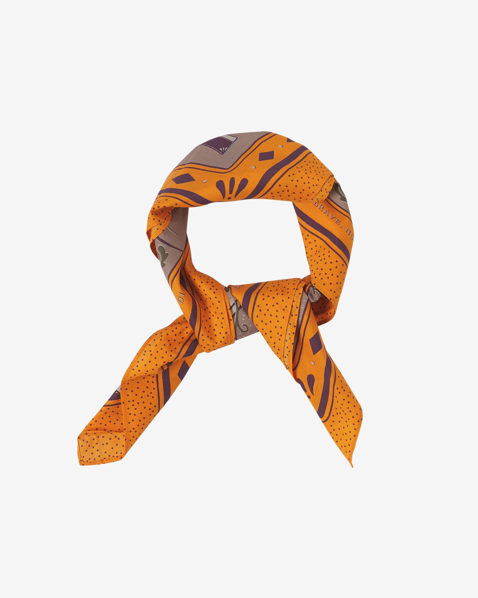 The Luck cotton bandana in browns, pink and a vivid, golden orange. Knotted and looped against a neutral background.