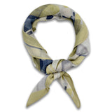 The Nevada bandana knotted loosely into a loop, showing the muted yellow and grey tones of the modal-wool fabric.