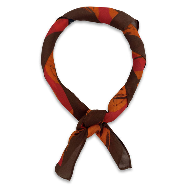 The Sierra bandana knotted into a loop, showing the bright, autumnal colours of the modal-wool fabric.