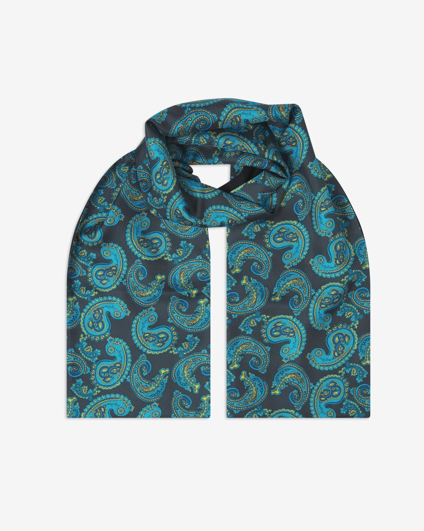 The Bridle wool-backed silk scarf. Unravelled and looped in the middle, showing the length, width and paisley pattern on silk.