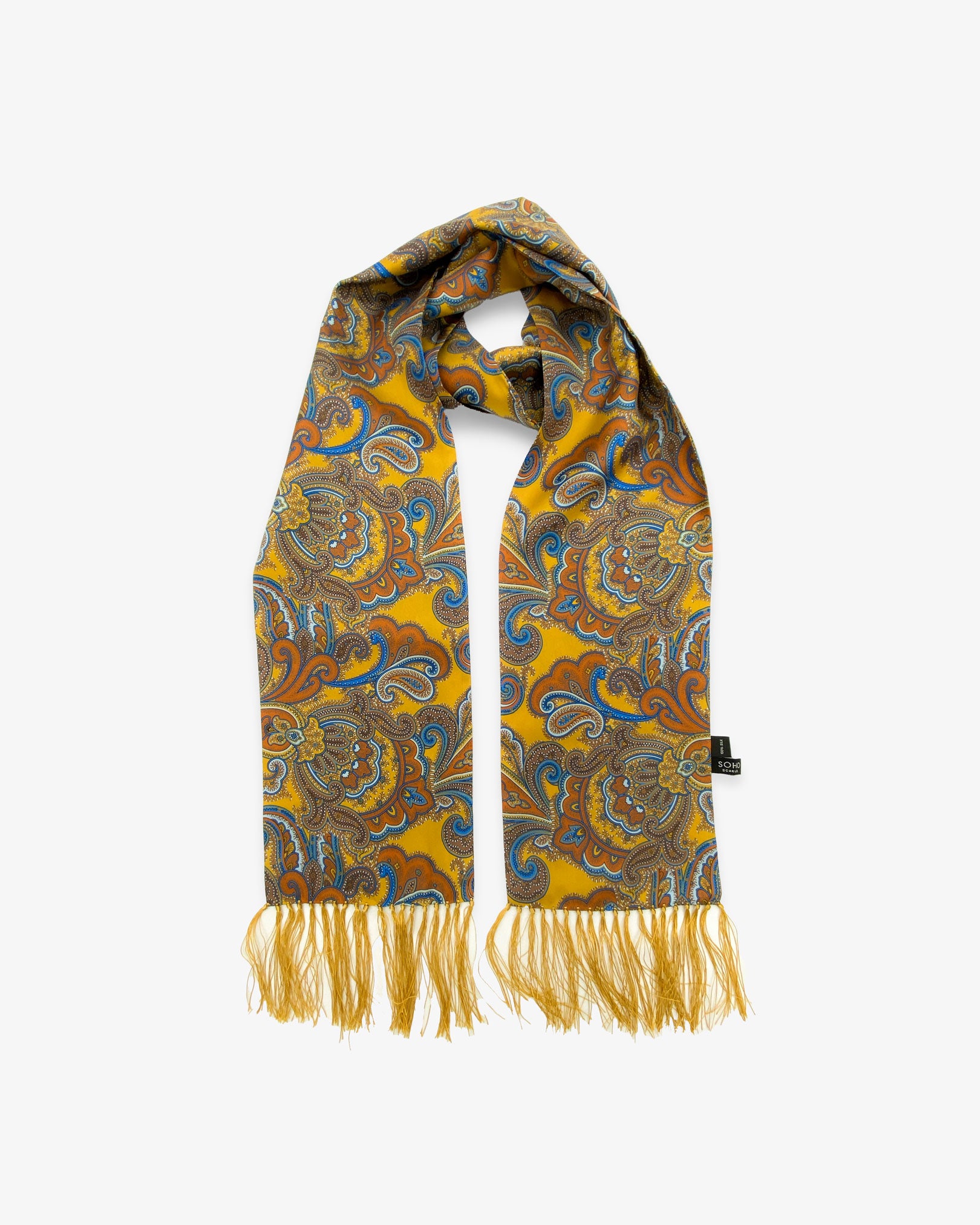 Looped view of the 'Carnaby' silk aviator scarf, clearly showing the golden yellow fabric with vibrant orange, brown and blue paisley patterns and a matching 3-inch fringe.