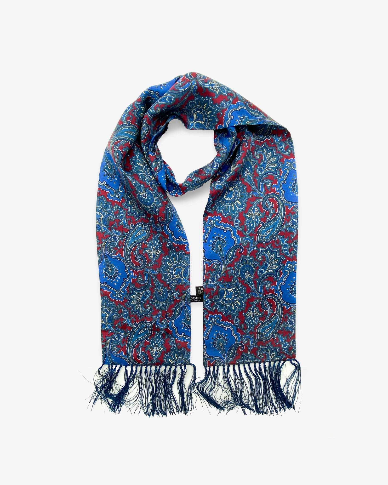 Looped view of the 'Dean' silk aviator scarf, clearly showing the burgundy and blue patterns and a matching 3-inch fringe.